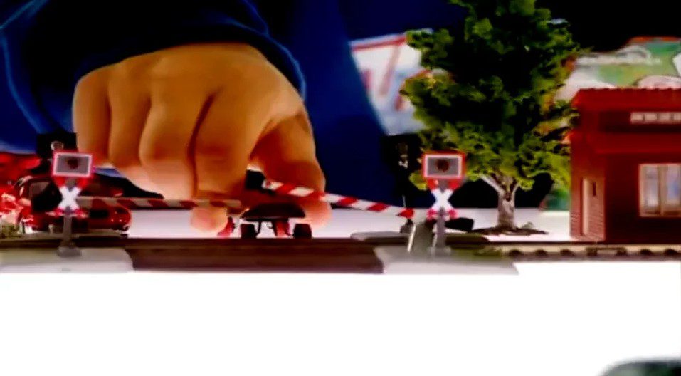 Child Playing With Miniature Train Track